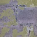 How are water-damaged concrete block walls repaired?